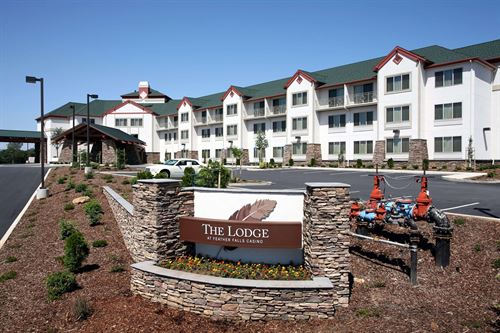 Lodge sign with hotel in background